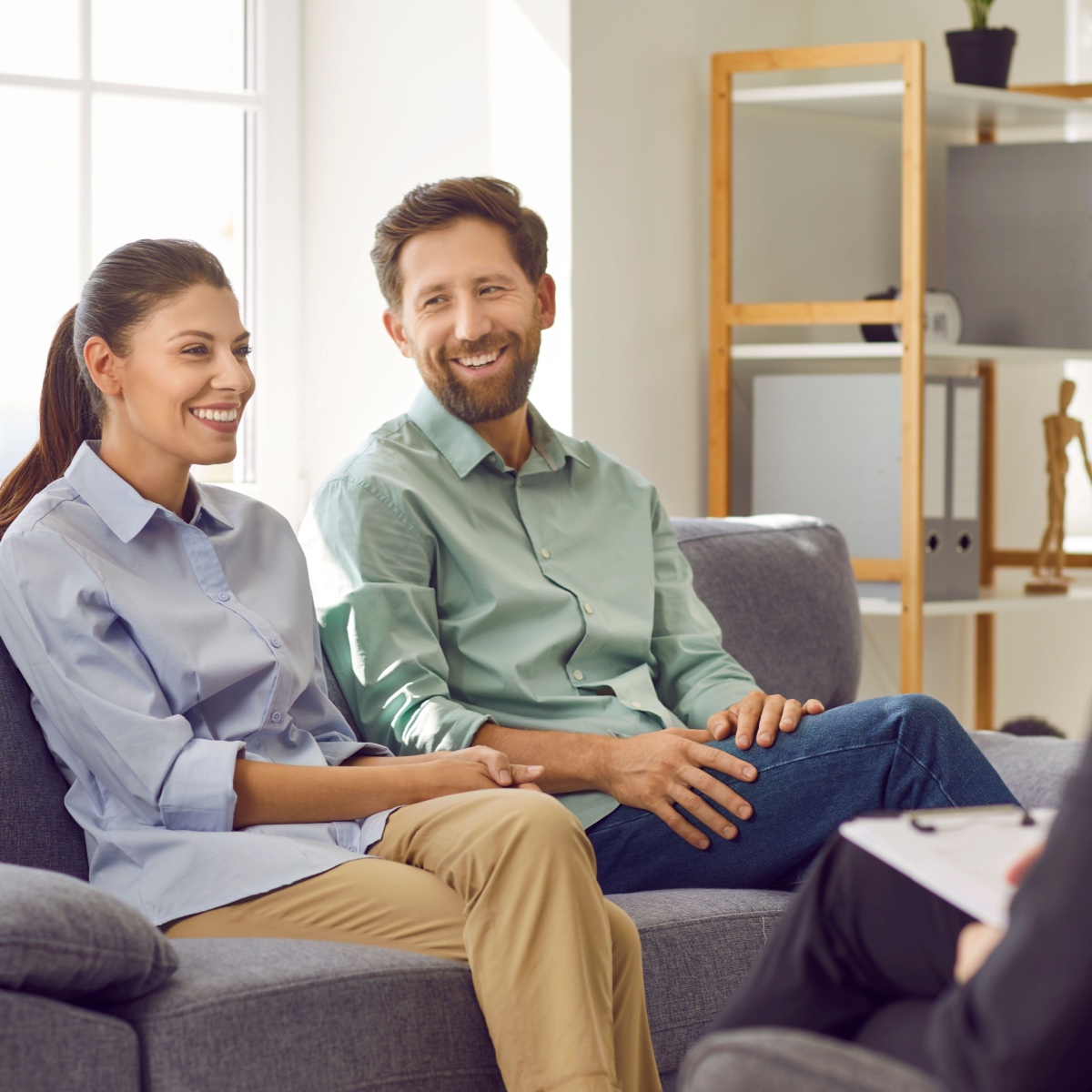 A happy couple talking to a fertility doctor